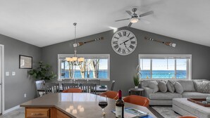 A spacious kitchen with a large island, dining area, and a view of the ocean. - Lakefront home, large firepit patio, Game room! (Brewerton)