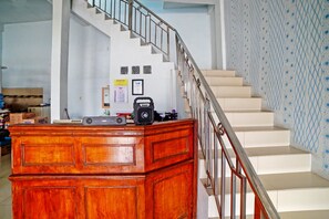 A staircase with a metal railing leading to a landing. - OYO 90922 Gurusinga Guesthouse (Medan)