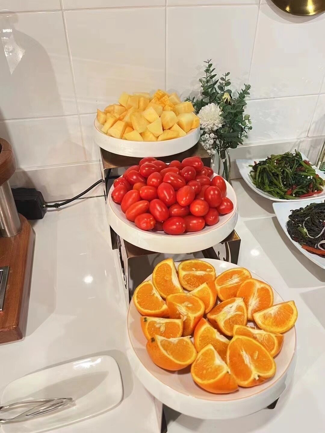A buffet table with various fruits and vegetables.