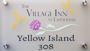 A sign for The Village Inn at Eastsound, Yellow Island, 308. - Yellow - Comfortably Accessible (Eastsound)
