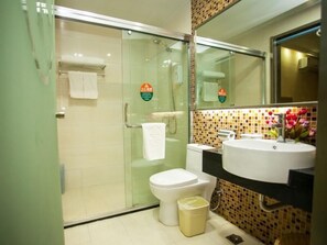 A modern bathroom with a glass shower enclosure, a toilet, a sink with a mirror, and a tiled backsplash. - Greentree Inn Jiangsu Xuzhou Feng County Liubang Plaza Express Hotel (Xuzhou)