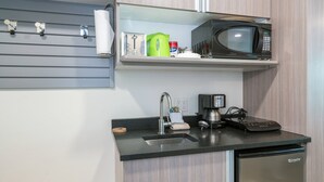 A compact kitchen with a built-in microwave, a coffee maker, and a sink. - Mountainside Inn 421 1 Bedroom Hotel Room by Alpine Lodging Telluride (Telluride)