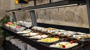 A buffet with various food items and utensils. - Wyndham Tarsus St.Paul (Tarsus)