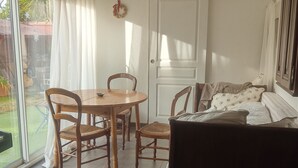 A room with a bed, a dining table with chairs, a large window, and a door. - House between sea and mountains located in a quiet cul-de-sac Animals accepted  (Pollestres)
