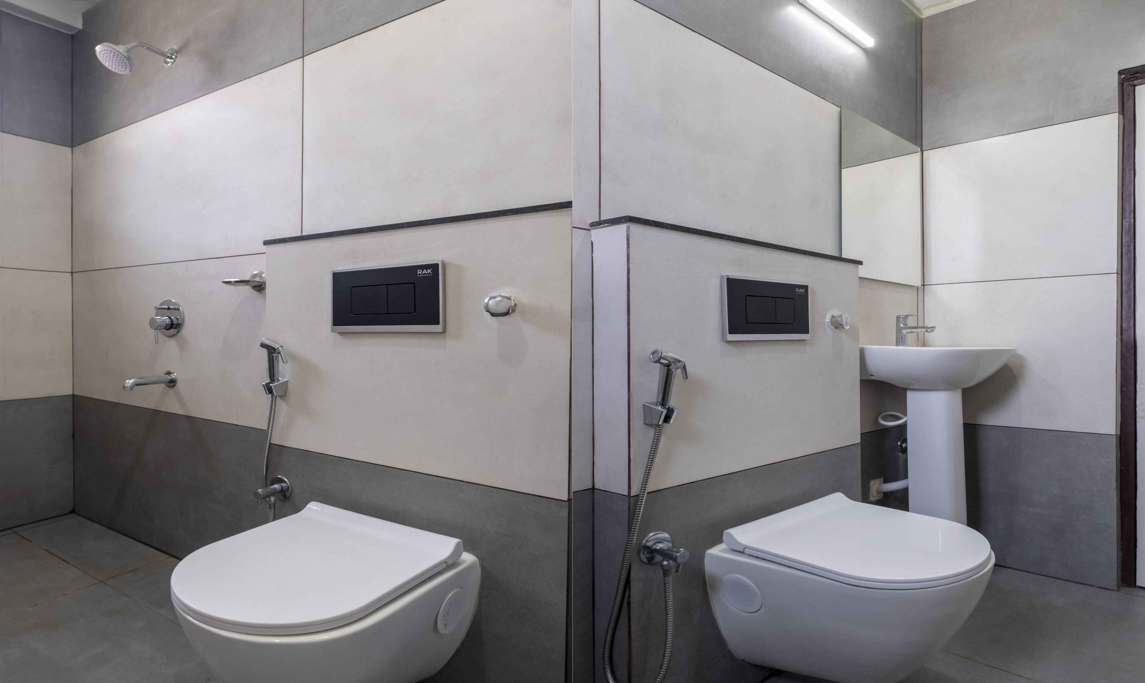 A modern bathroom with two toilets, a sink, and a shower.