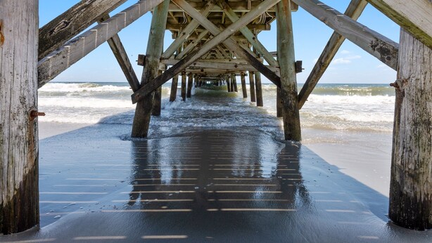 A wooden pier structure with a view of the ocean. - Luxe Home w/ Free Htd Pool, 50 Steps to Beach, Elevator, Putting Green, Tiki Bar (North Myrtle Beach)