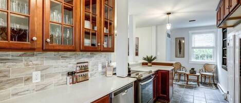A kitchen with wooden cabinets, a dishwasher, and a stove.