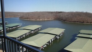 A marina with multiple docks and green canopies over the docks.