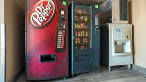 A Dr Pepper vending machine, a beverage dispenser, and an air conditioning unit. - Quality Inn Brookhaven, MS (Brookhaven)