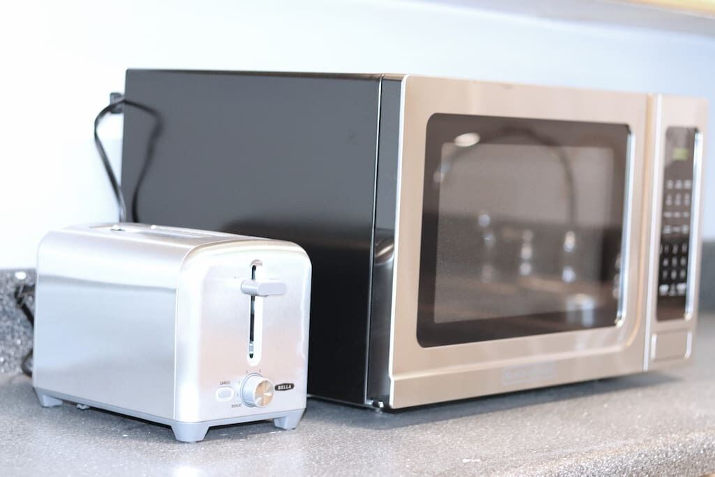 A kitchen with a toaster and a microwave.