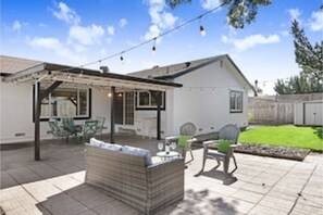 Relax in a, secure backyard with a covered patio area, perfect for outdoor dining or unwinding.