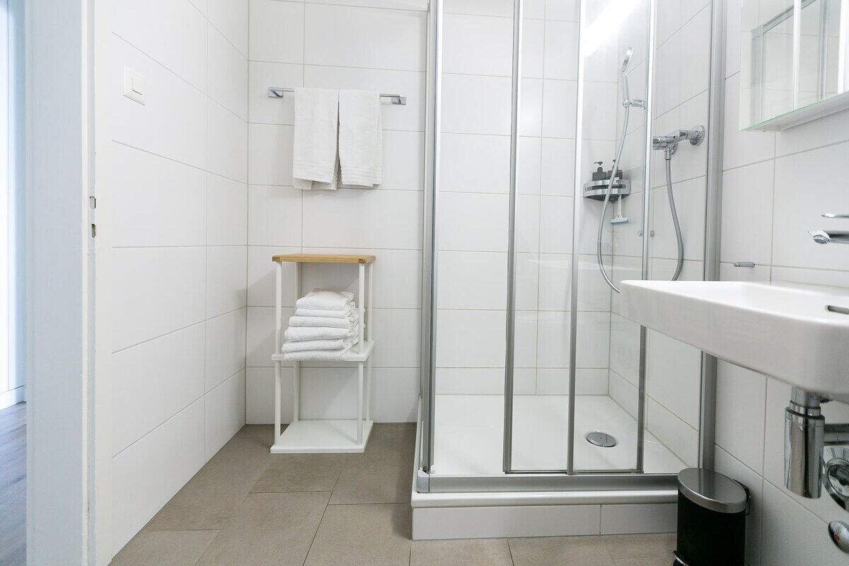 Bathtub, hair dryer, towels, shampoo