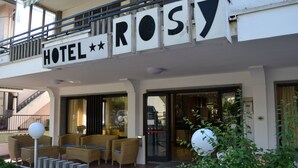 A hotel named "HOTEL ROSY" with outdoor wicker furniture and a visible entrance. - Hotel Rosy (Bellaria-Igea Marina)