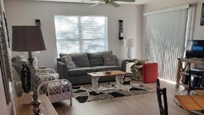 A living room with a sofa, coffee table, and TV.