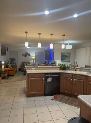 Enjoy cooking in this well-equipped kitchen with a central island, dishwasher, and sink.