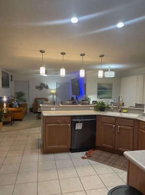 Enjoy cooking in this well-equipped kitchen with a central island, dishwasher, and sink.