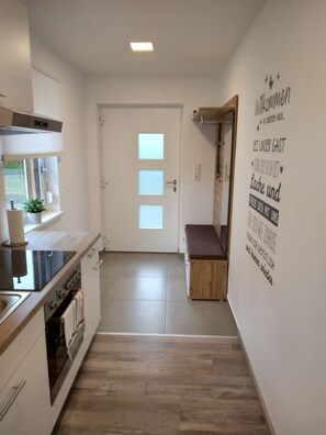 Fridge, stovetop, dishwasher, coffee/tea maker