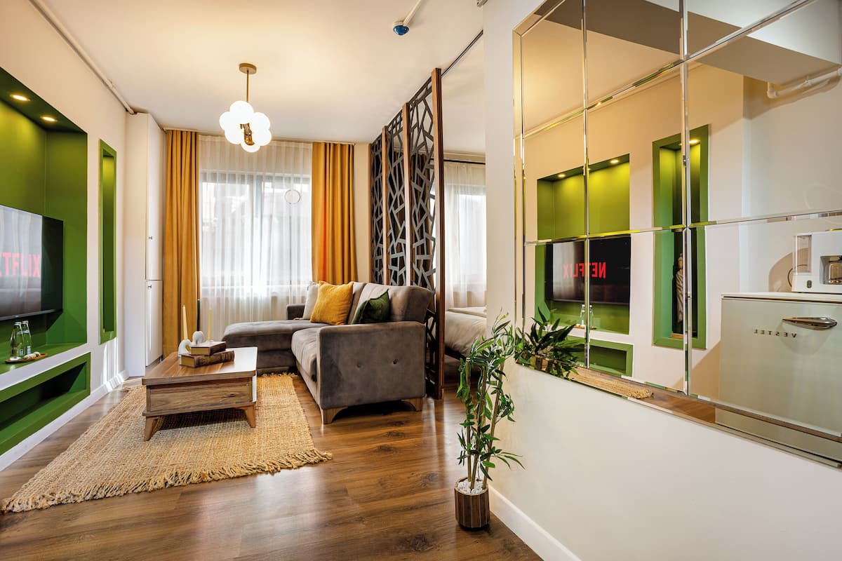 A modern living room with a sofa, coffee table, and a TV.
