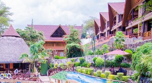 A resort with a pool, thatched-roof structures, and lush greenery. - Panorama Park Resort Naivasha (Naivasha)