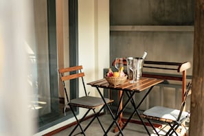A foldable table with a basket of fruit, a glass, and a metal container. - My Dream Boutique Resort (Luang Prabang)
