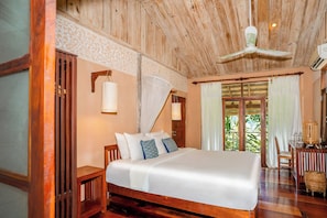 A spacious bedroom with a large bed, wooden ceiling, and a view of greenery outside. - My Dream Boutique Resort (Luang Prabang)