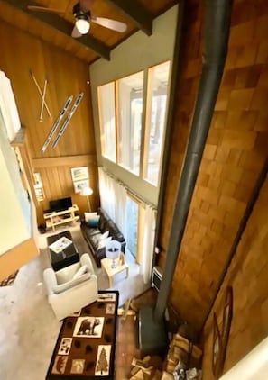 A cozy cabin interior with a fireplace, wooden walls, and a dining area. - Mammoth Awesome Location-1 min to Shuttles & Food TOML-CPAN-11402 (Mammoth Lakes)