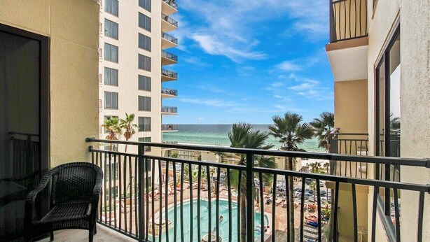 A balcony with a view of a pool and beach. - Vacation Station 716-Ocean View-Sleeps 4 (Panama City Beach)