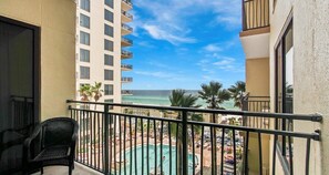 A balcony with a view of a pool and beach. - Vacation Station 716-Ocean View-Sleeps 4 (Panama City Beach)