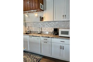 Enjoy cooking in this well-equipped kitchen with appliances, including a dishwasher, coffee maker, and microwave.