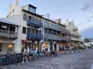 A street with historic buildings, bicycles parked along the sidewalk, and people walking. - Dragana's Paradise 30A 410-Pool-Sleeps 2 (Seacrest Beach)