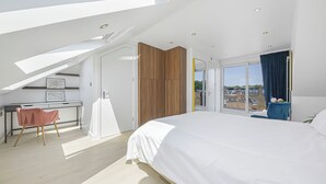 A modern bedroom with a large bed, a desk, and a chair. - Oversize 3Bed 2bath Victorian Penthouse w/ AC in Maida Vale (London)