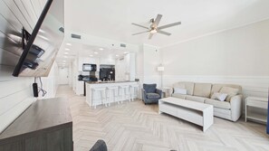 A modern living space with a kitchen, dining area, and seating area.