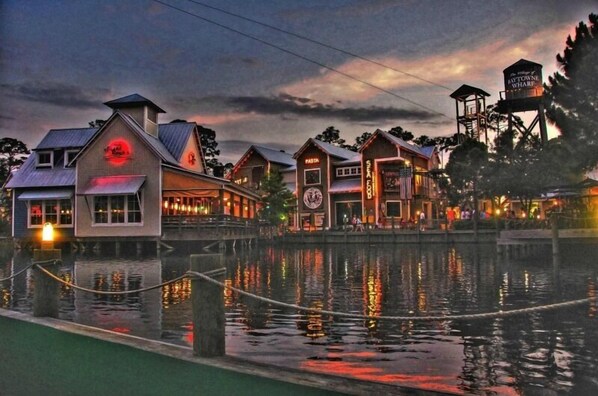 Waterfront property with a rustic architectural style, featuring a restaurant and dock area.