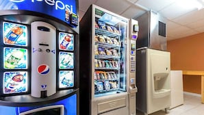 A vending machine with a Pepsi logo and a selection of snacks. - Super 8 by Wyndham Greensburg/Latrobe (Greensburg)
