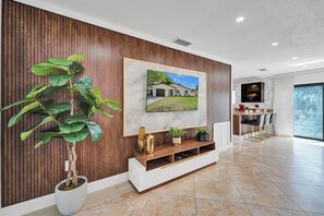 Enjoy a welcoming atmosphere with a framed photograph, potted plant, and communal dining area.