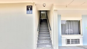 A staircase leading to a building labeled "BUILDING 1" with a window and air conditioning unit visible. - Americas Best Value Inn San Antonio Airport South (San Antonio)