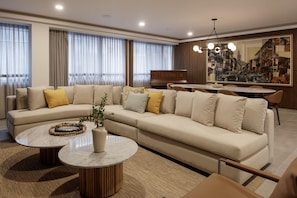 Presidential Studio Suite | Living area | 65-inch Smart TV with cable channels, TV