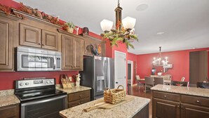A kitchen with wooden cabinets, stainless steel appliances, and a granite countertop. - Summer Snow: Large Pet-Friendly Family Home w Yard, Firepit | 6 Min to Downtown (Highlands)