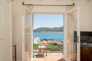 Enjoy breathtaking views of the sea and distant hills from this expansive balcony.