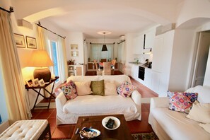 Relax in this spacious living area with a sofa, coffee table, and dining space.