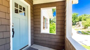 A house entrance with a light blue door, a small window, and a welcome mat. - Modern and comfy home five minutes from downtown (Hannibal)