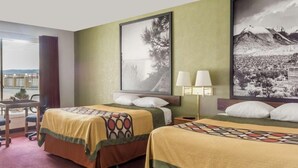 A hotel room with two beds, a desk, and a view of the outdoors. - Super 8 by Wyndham Wells (Wells)