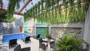 An indoor pool area with lounge chairs and potted plants. - Hotel El Marques de Manga (Cartagena)