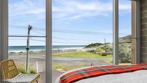 A room with a large window overlooking a coastal road and ocean. - Six Degrees - Across the road from the Separation Creek beach (Separation Creek)