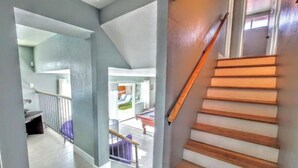 A staircase with wooden steps and a handrail, leading to an upper floor. - Oasis w/Opt Heated Pool & Billiards- Mins to Strip (Las Vegas)