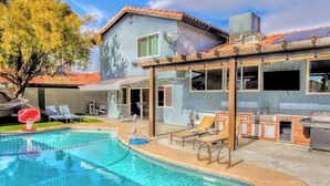 A residential property with a swimming pool, outdoor seating, and a barbecue area. - Oasis w/Opt Heated Pool & Billiards- Mins to Strip (Las Vegas)