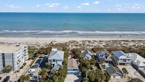A coastal residential area with beachfront properties, a parking lot, and a hotel named 'Park Place'.