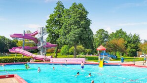 A swimming pool with multiple lanes, a water slide, and a playground area. - 2 bedroom stunning home in Heinkenszand (Heinkenszand)