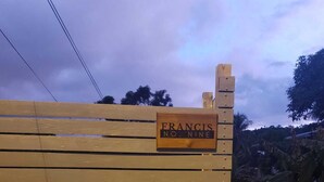 A wooden gate with a sign reading "FRANCIS NO. NINE." - Cozy Nook nestled in the Santa Cruz Valley. 
Queen sized bed Hot and cold shower (Santa Cruz)