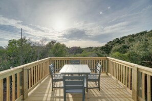 Guests can enjoy meals and relaxation on the deck with a table and chairs.